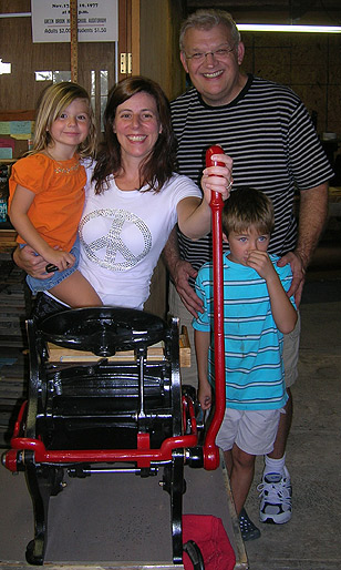 Dennis Couch
                                & Family with their new printing
                                press!