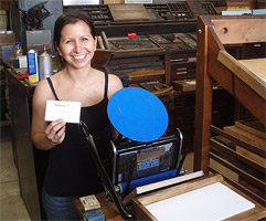 Jenifer with the first print from her restored
                    Kelsey Victor press