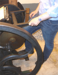 Carl Smith "Kicking the
                  treadle" on an old platen press