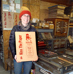 Film maker
                  Fiona Owtway with her new posters at the Vandercook
                  they were printed on.