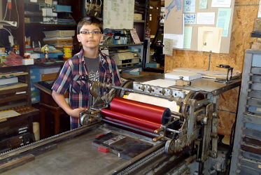 Aiden printing on the Vandercook