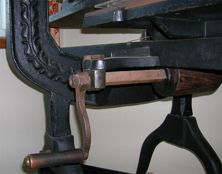 Iron hand press bed crank mechanism